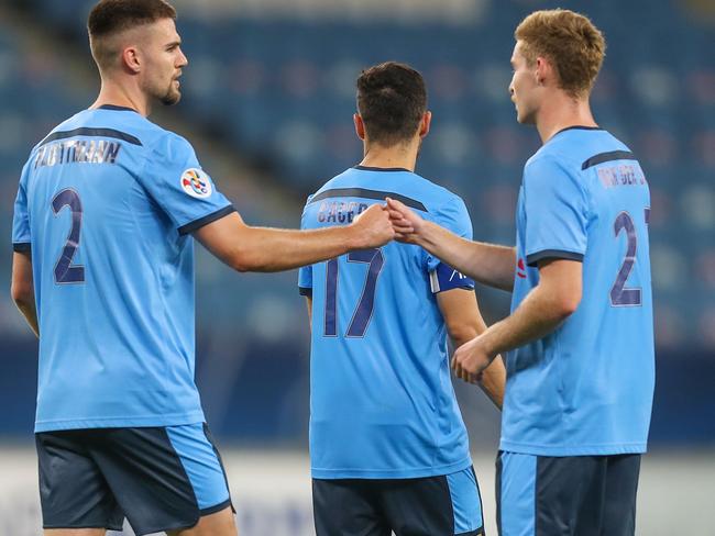 Sydney's players celebrate their win during the AFC Champions League group H football match between China's Shanghai SIPG and Australia's Sydney FC on December 1, 2020 at the al-Janoub Stadium in the Qatari city of Al Wakrah. (Photo by KARIM JAAFAR / AFP)