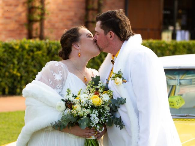 The newlyweds share a kiss before joining their guests for the festivities.