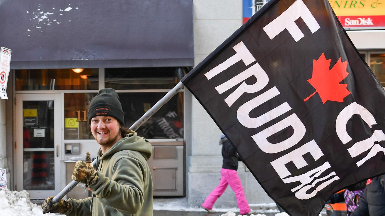 A protester holds up a flag showing his displeasure with the mandates imposed by the Prime Minister of Canada Justin Trudeau. Picture: AFP