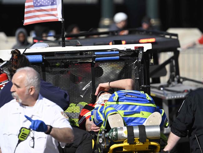 A victim is aided after shots were fired near the Kansas City Chiefs' Super Bowl LVIII victory parade in Kansas City, Missouri. Picture: AFP