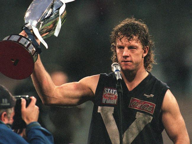 Garry Hocking holding the State of Origin cup trophy after the final AFL origin game in 1999.