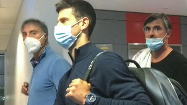 Serbian tennis player Novak Djokovic walks with his team after landing at Dubai Airport. Picture: AFPTV / AFP