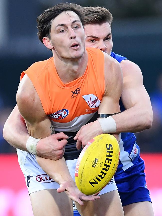 Jake Stein handballs during his AFL debut for the GWS Giants against North Melbourne. Picture: Quinn Rooney/Getty Images