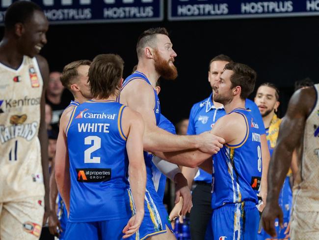 Teammates restrain Aron Baynes. Picture: Russell Freeman/Getty Images