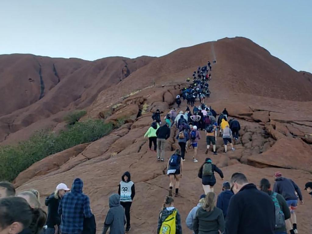 This handout photo taken on September 25, 2019 courtesy of @koki_mel_aus on Instagram shows tourists climbing Uluru in Australia's Northern Territory. Picture: @koki_mel_aus.