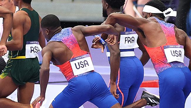 PARIS, FRANCE - AUGUST 09:  Christian Coleman of Team United States (3R) attempts to pass the baton to team mate Kenneth Bednarek (R) in the Men's 4x100m Relay Final on day fourteen of the Olympic Games Paris 2024 at Stade de France on August 09, 2024 in Paris, France. (Photo by Patrick Smith/Getty Images)