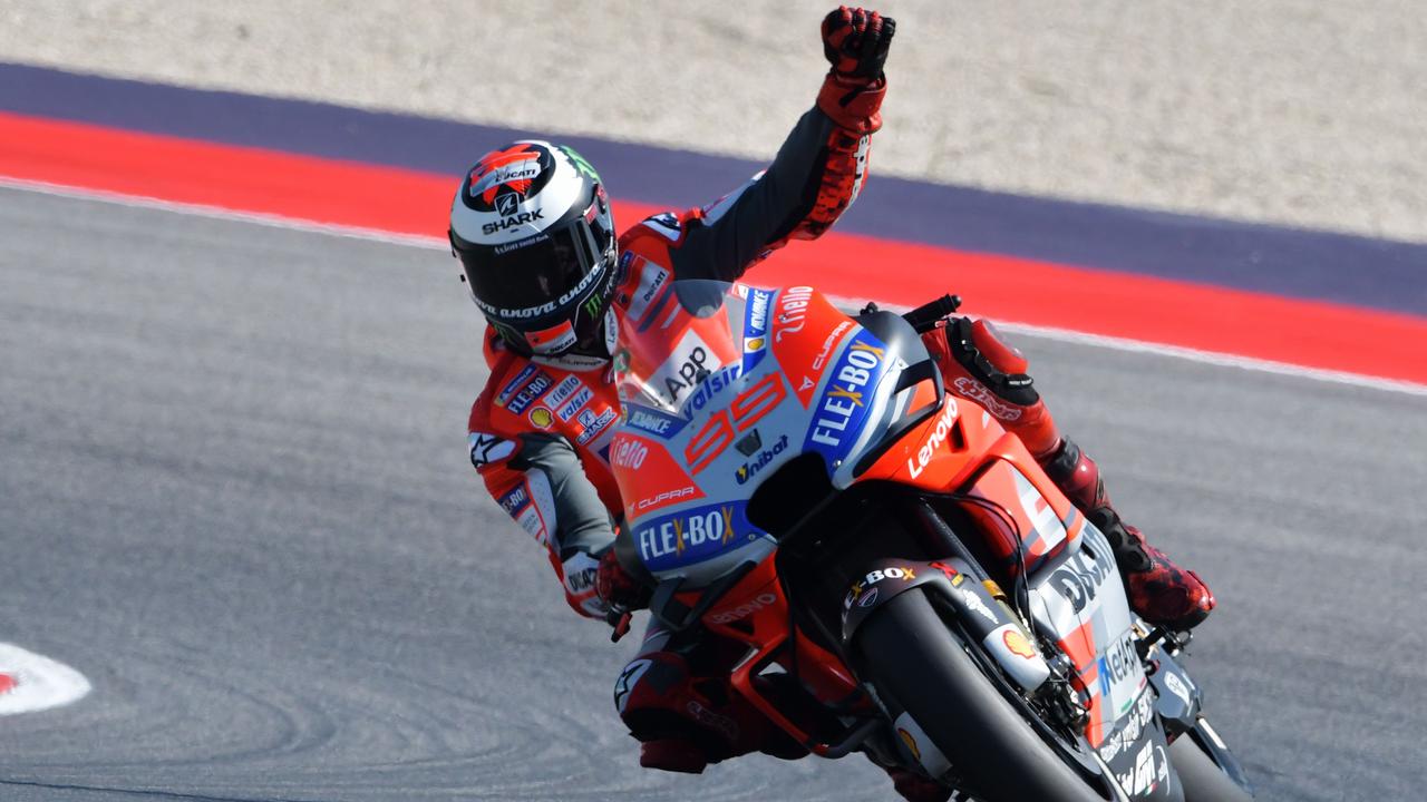 Ducati Team's Spanish rider Jorge Lorenzo celebrates winning pole position.