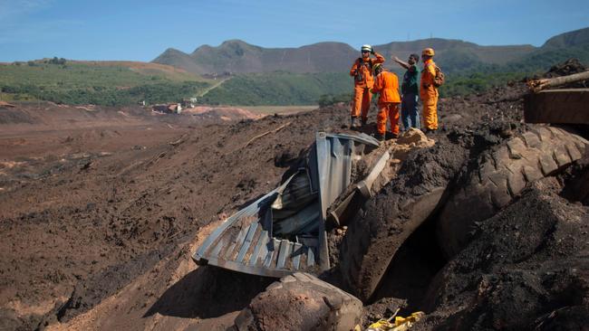 Firefighters search for victims after a dam collapsed at an iron-ore mine belonging to Brazil's giant mining company Vale.