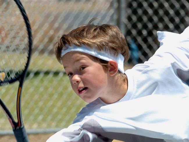Oliver Florent as a six-year-old playing against former world No.1 Andy Roddick during a charity tournament in Melbourne.