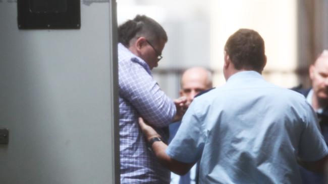 Benjamin McCartin being led out of a prison van into the Supreme Court prior to a pre-sentence hearing over the death murder of Ricky Rowlands. Picture: NCA NewsWire / David Crosling