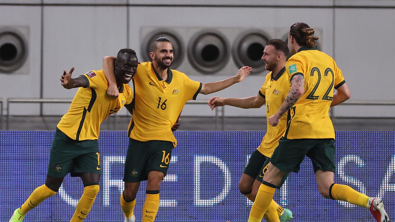 Australia's Awer Mabil (L) celebrates the first goal for the Socceroos against China.
