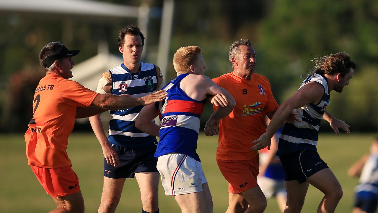 Trinity Bulldogs Brian Durbidge throws a punch towards Port Douglas player as Port trainer Glenn Dickson (second from right) tries to intervene to separate them) during the Port Douglas and Centrals Trinity Beach Bulldogs AFL Cairns preliminary final at Cazalys. PICTURE: JUSTIN BRIERTY