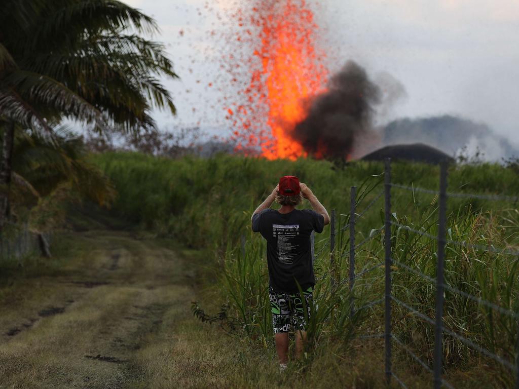 A man takes a photo of a lava fountain from a Kilauea volcano fissure on Hawaii's Big Island. Mario Tama/Getty Images/AFP