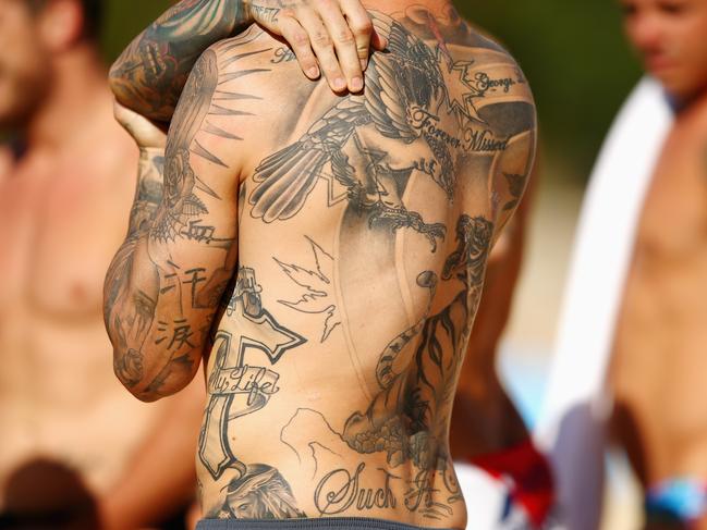 SYDNEY, AUSTRALIA - MAY 02: The tattoos of Josh Dugan are seen during the Australia Kangaroos Test team recovery session at Coogee Beach on May 2, 2016 in Sydney, Australia. (Photo by Mark Kolbe/Getty Images)