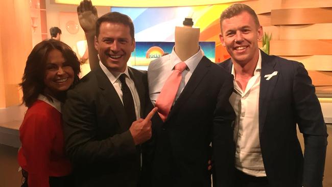 The suit’s winning bidder Rohan Gull collects the ‘stanky’ suit from Today’s Karl Stefanovic and Lisa Wilkinson.