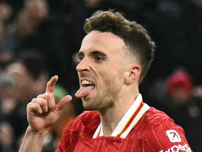 Liverpool's Portuguese striker #20 Diogo Jota celebrates after scoring their second goal during the English Premier League football match between Liverpool and Fulham at Anfield in Liverpool, north west England on December 14, 2024. (Photo by Oli SCARFF / AFP) / RESTRICTED TO EDITORIAL USE. No use with unauthorized audio, video, data, fixture lists, club/league logos or 'live' services. Online in-match use limited to 120 images. An additional 40 images may be used in extra time. No video emulation. Social media in-match use limited to 120 images. An additional 40 images may be used in extra time. No use in betting publications, games or single club/league/player publications. /