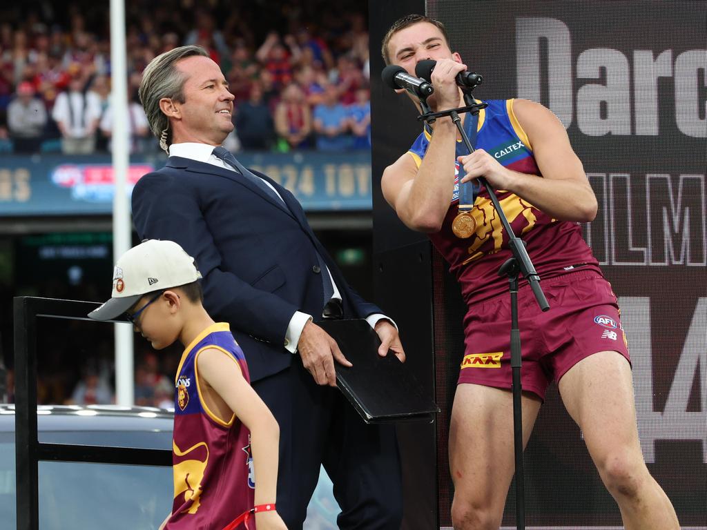 Darcy Wilmot grabs the microphone after receiving his premiership medal on the dais. Picture: Lachie Millard