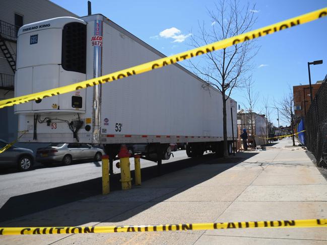 Refrigerated trailers are parked outside of the Wyckoff Heights Medical Centre in Brooklyn as New York State's death toll rises to 3565. Picture: AFP