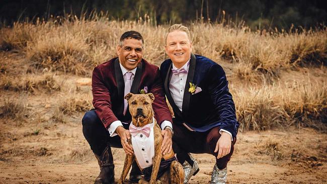 LOVE IS LOVE: Malcome Mitchell and husband Ian McDonald with their dog, Kronk, at their wedding in Mitchell on Saturday. Picture: KATRINA AYERS