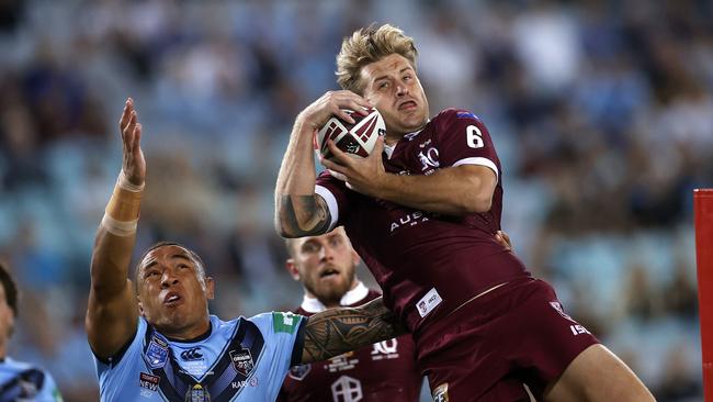 QLD's Cameron Munster takes bomb and is concussed in tackle during Game 2 of the State of Origin series between the NSW Blues and Queensland Maroons at ANZ Stadium. Picture. Phil Hillyard