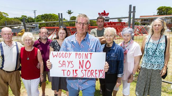 Derek Catterall poses for a photograph with neighbours of the development site bounded by Kate Street, Lilla Street, and Gayundah Esplanade in Woody Point. PHOTO: AAP /Richard Walker