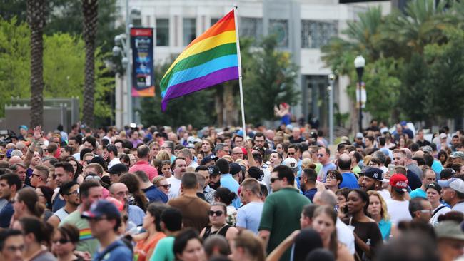 People gather at a vigil for the victims of a mass shooting at the Pulse nightclub at Dr Phillips Performing Arts Center in downtown Orlando. Picture: Ricardo Ramirez Buxeda/Orlando Sentinel via AP