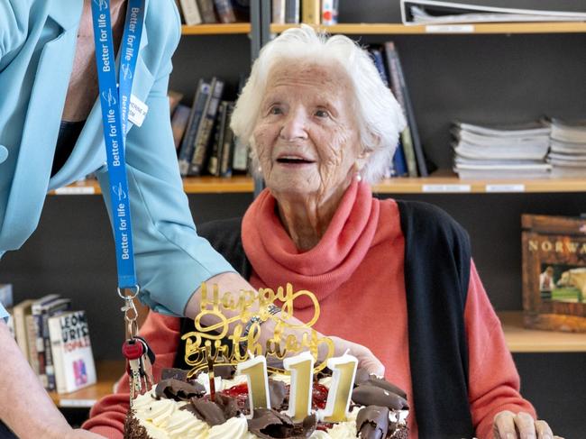 EMBARGO FOR TWAM 21 OCT 2023. FEE MAY APPLY. Catherina celebrating ahead of her 111th birthday - cake being delivered by West Beach Residential Care Manager, Catherine Willoughby, 18 August 2023. Australiaâs oldest living person, Catherina van der Linden, will celebrate her 111th birthday later this week (Saturday, August 26). Mrs van der Linden lives in Southern Cross Careâs West Beach Residential Care home in South Australia and credits her outstanding longevity to her active lifestyle, which still includes twice-weekly gym sessions and regular walks.