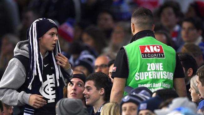 Security speak to a fan at the Carlton-Western Bulldogs clash at Marvel Stadium. Pic: Getty Images