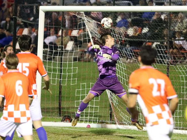 Knights goalkeeper Joshua Langdon gifts Broadbeach’s Tomoki Asakawa a goal. Picture: Richard Gosling