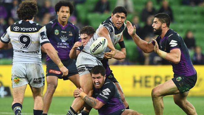 MELBOURNE, AUSTRALIA — JUNE 17: Jason Taumalolo of the Cowboys passes the ball while being tackled during the round 15 NRL match between the Melbourne Storm and the North Queensland Cowbpys at AAMI Park on June 17, 2017 in Melbourne, Australia. (Photo by Quinn Rooney/Getty Images)