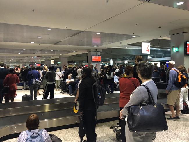 Wild weather: Lightning causes delays at Sydney Airport | Daily Telegraph