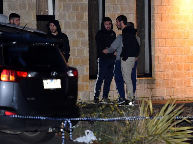 Men outside a nearby house this morning.