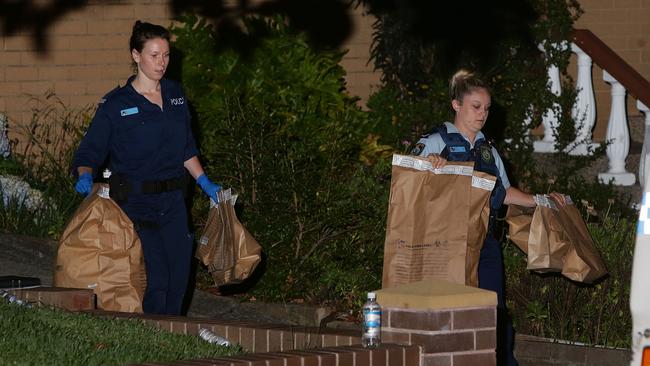 Police carry bags of evidence from the Ashbury home. Picture: Bill Hearne