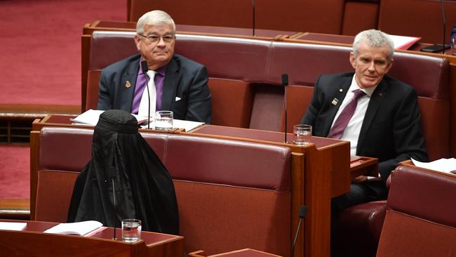 MPs look on as One Nation leader Pauline Hanson dons a burqa in parliament. Picture: AAP Image/Mick Tsikas