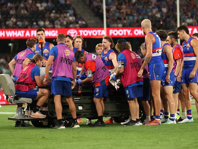 Western Bulldogs players check on Luke Cleary. Picture: Kelly Defina/AFL Photos