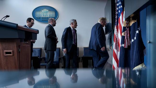 US Secretary of the Treasury Steven Mnuchin, Director of the Office of Management and Budget Russell Vought, member of the coronavirus task force Scott Atlas, and US President Donald Trump leave after a briefing at the White House. Picture: AFP