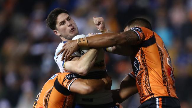 Mitchell Moses is wrapped up by the Tigers’ defence. Picture: Jason McCawley/Getty Images