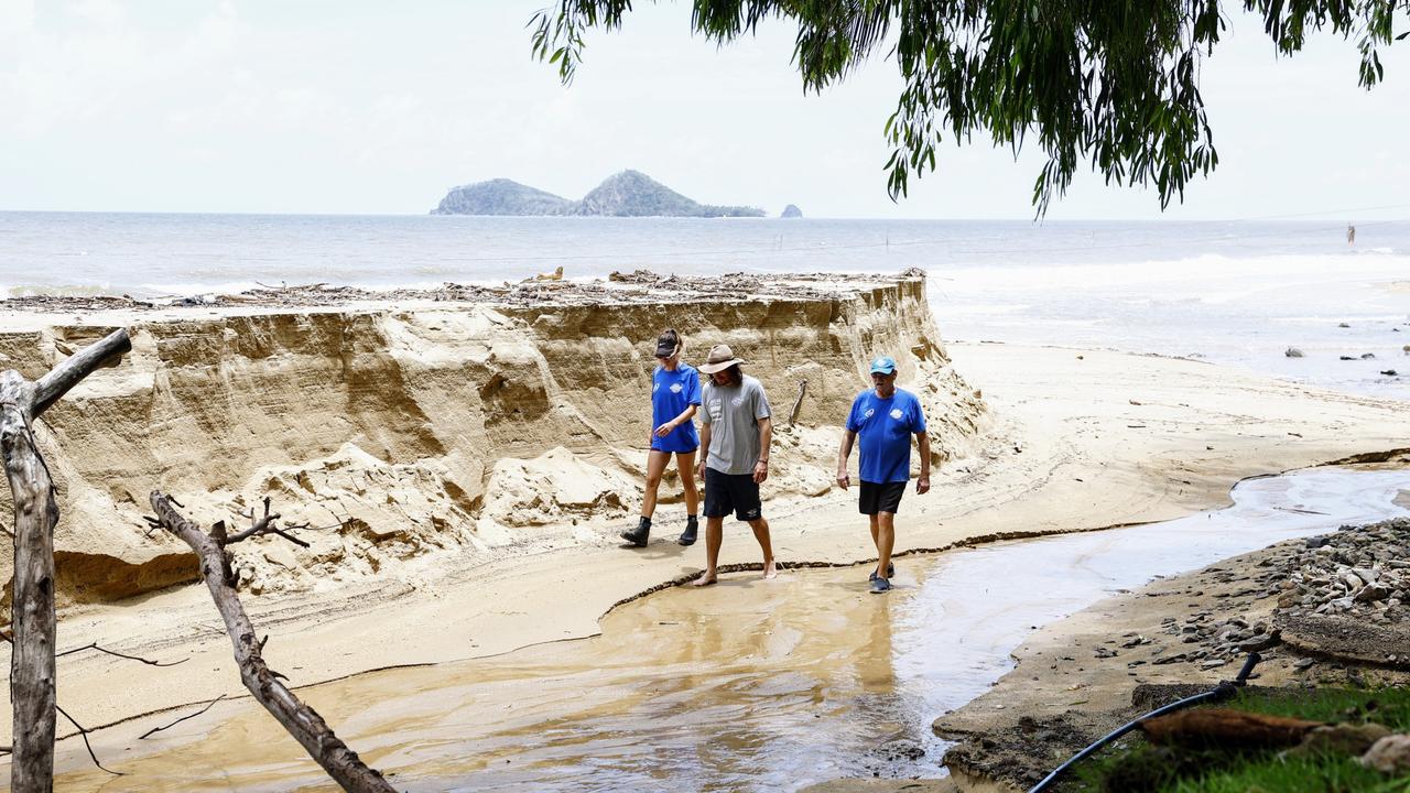 The members walk along the beach after flood waters caused huge erosion. Picture: Brendan Radke