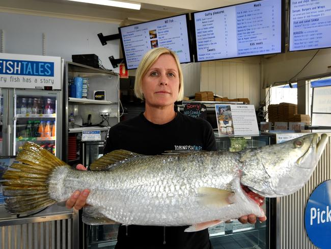 Renae Tobin from Tobin Fish with a wild-caught barra at the North Ward store. Picture: Evan Morgan