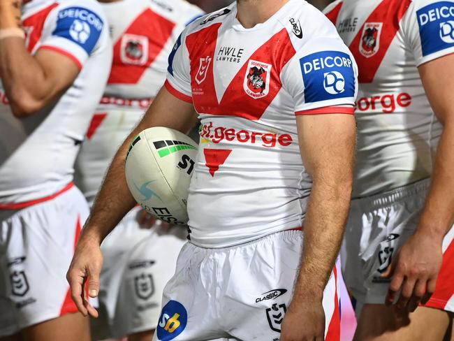 A dejected Dragons group wait behind the posts after conceding a try. Credit: NRL Images.