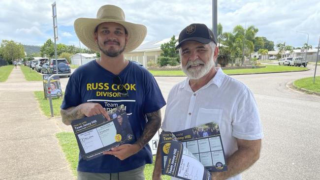 Volunteers Travis Cook and Mario La Fauci hand out 'How to Vote' cards at Willows State School in Division 5. Picture: Chris Burns