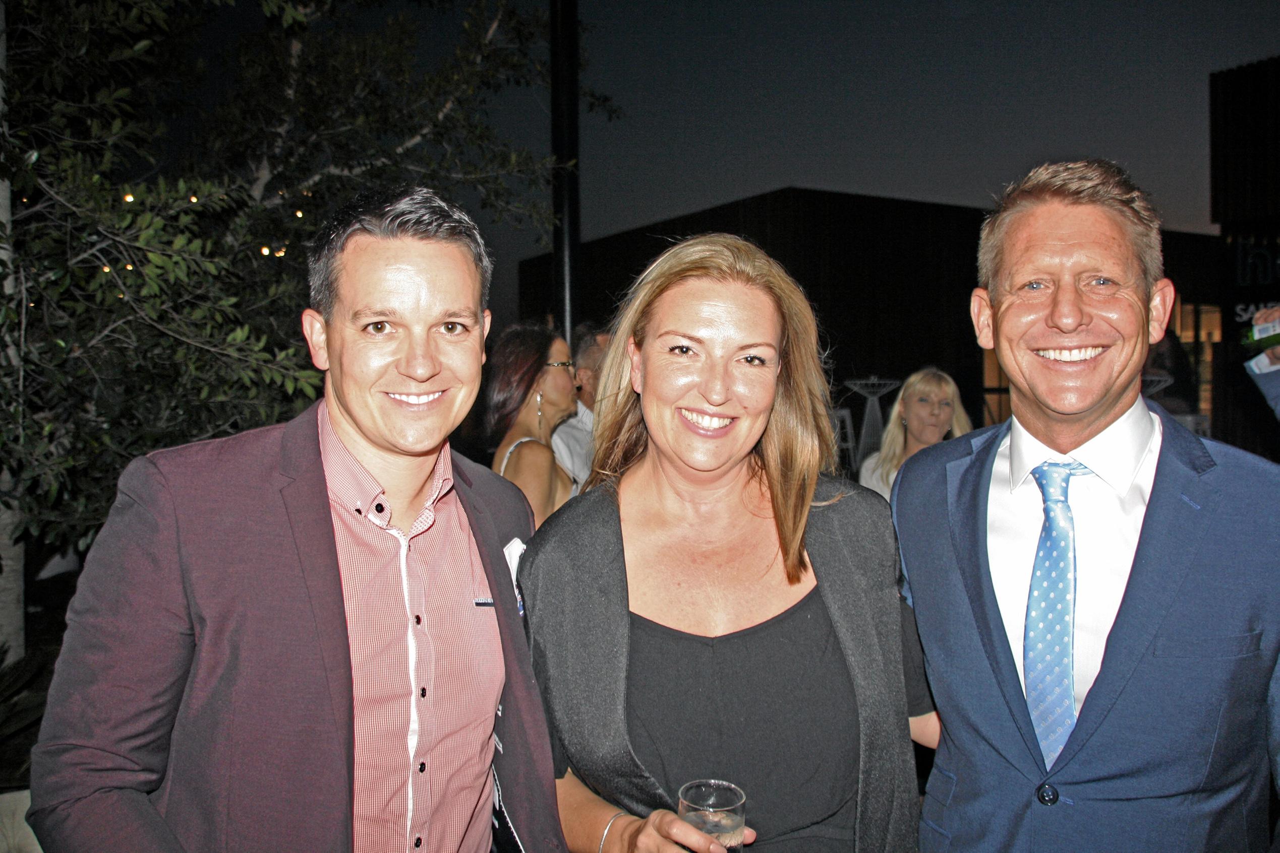 Gary Burkert and Melissa Wolfe of Plantation Homes with Andrew Boulding of Metricon at AVID Property Group's launch of its new sales and information centre in Palmview's master-planned community of Harmony. Picture: Erle Levey