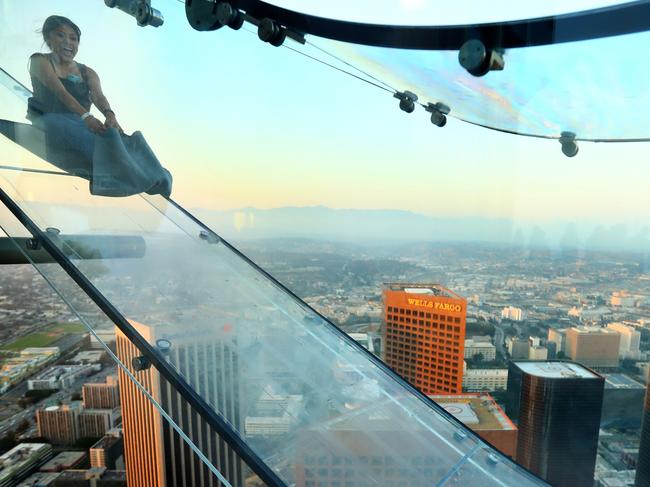 LOS ANGELES, CA - JUNE 25: A guest rides the SkySlide during the OUE Skyspace LA grand opening block party at OUE Skyspace LA on June 25, 2016 in Los Angeles, California. (Photo by Mark Davis/Getty Images for Ogilvy PR)