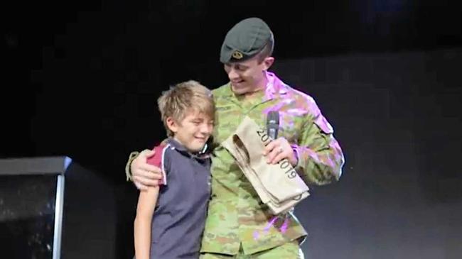 William Anderson is reunited with his father Lieutenant Michael Anderson at a Highlands Christian College school assembly on March 8. Picture: Contributed