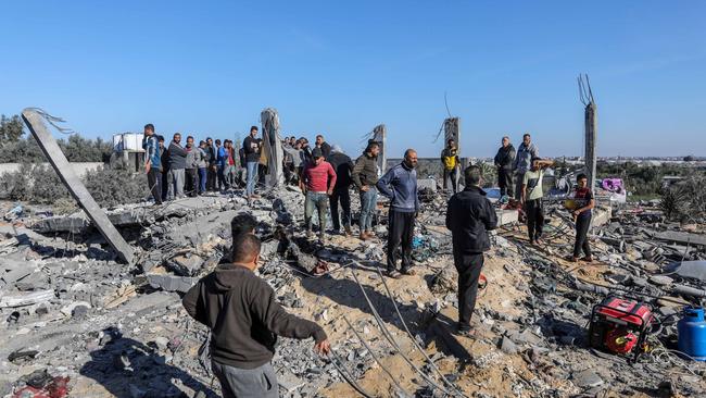 People search for victims in a building that was destroyed during Israeli air strikes in Rafah, Gaza. Picture: Getty Images