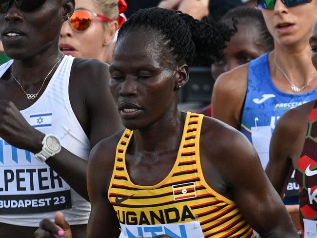 (FILES) (From L to R) Kenya's Rosemary Wanjiru, Israel's Lonah Chemtai Salpeter, Uganda's Rebecca Cheptegei and Kenya's Selly Chepyego Kaptich compete in the women's marathon final during the World Athletics Championships in Budapest on August 26, 2023. A Ugandan marathoner who competed at the Paris Olympics is in intensive care after  being set on fire alledgedly by her partner in Kenya, officials said on September 3, 2024, the latest horrific incident of gender-based violence in the East African country. Long-distance runner Rebecca Cheptegei, 33, was assaulted after her Kenyan partner Dickson Ndiema Marangach reportedly snuck into her home in western Trans-Nzoia county on September 1, 2024 at around 2:00 pm while she and her children were at church, police said. (Photo by Ferenc ISZA / AFP)