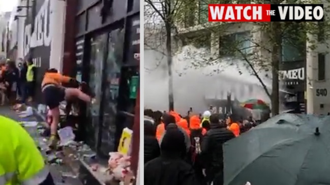 Construction workers smash the front of the CFMEU HQ in Melbourne