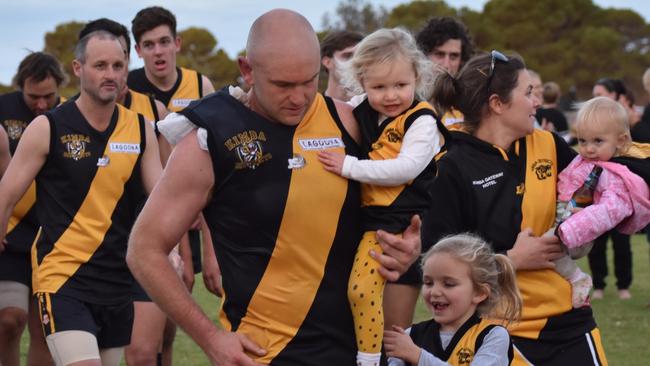 Fitzgerald gets a hug from his family — eldest daughter Millie, wife Nicole and Sophie and Oakley. Picture: Felicity Chinnery