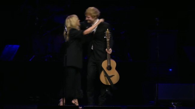 Kylie Minogue hugs Ed Sheeran after their performance.