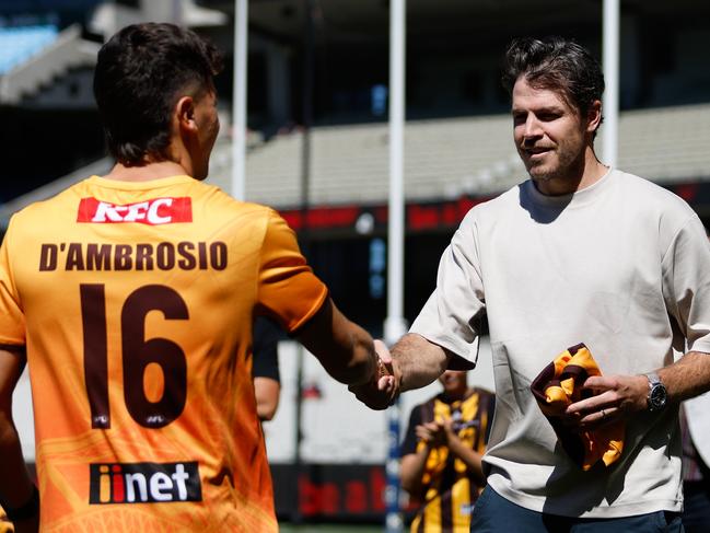 Isaac Smith presenting Massimo D'Ambrosio with his Hawthorn jumper. Picture: Dylan Burns/AFL Photos